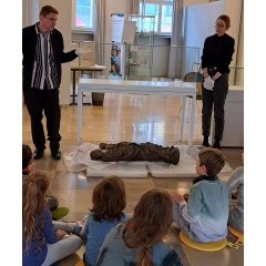 Workshop 5: Vor den Augen der interessierten Kinder wird die Holzskulptur der Jungfrau mit dem Kind für die Vitrine vorbereitet. Gute Chance, um sie genau in Augenschein zu nehmen. Museologen Veronika Nuding und Benjamin Schröder beantworten Fragen.