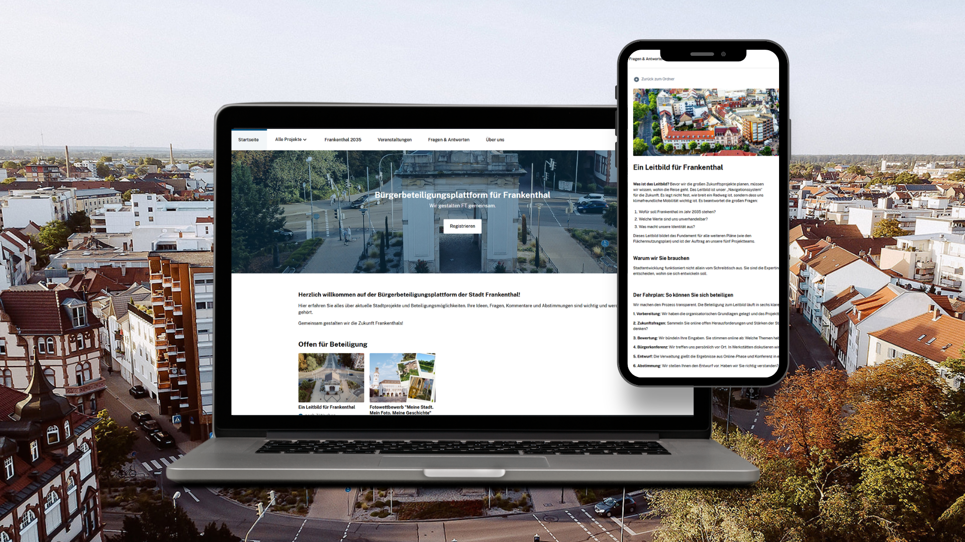 Laptop- und Handy-Bildschirm mit Stadtansicht von oben