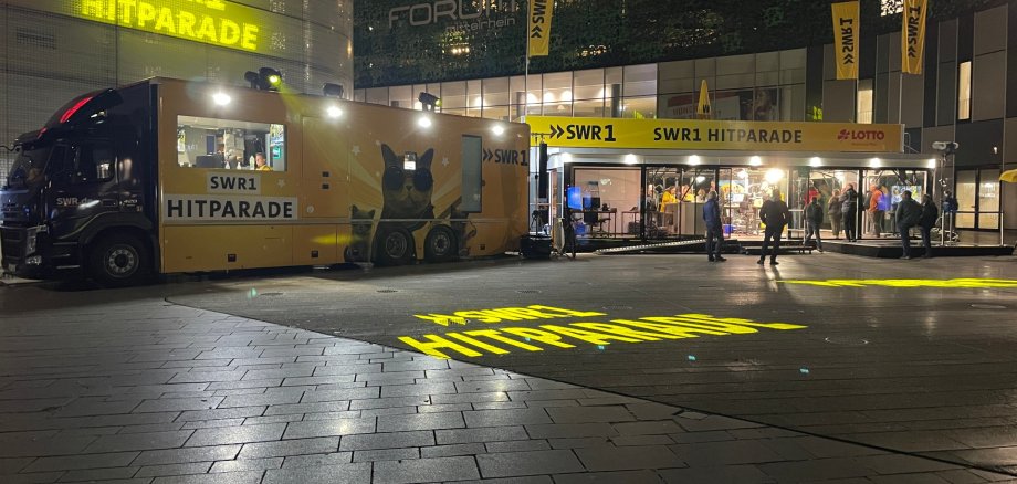 LKW mit mobilem Radio-Studio auf Platz bei Nacht