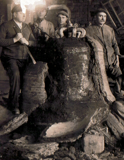 Szene in der Gießerei Hamm, vor dem Zweiten Weltkrieg: "Geburt" einer Glocke. Der Lehmmantel wird zerschlagen, die gegossene Glocke kommt zum Vorschein. Das Ereignis wurde fotografisch mit dem Team festgehalten.
