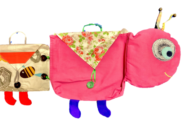 Das Bücherwürmchen der Stadtbücherei Frankenthal Der Wurm auf weißem Hintergrund besteht aus farbigen Stofftaschen, in die Bücher gelegt werden können.